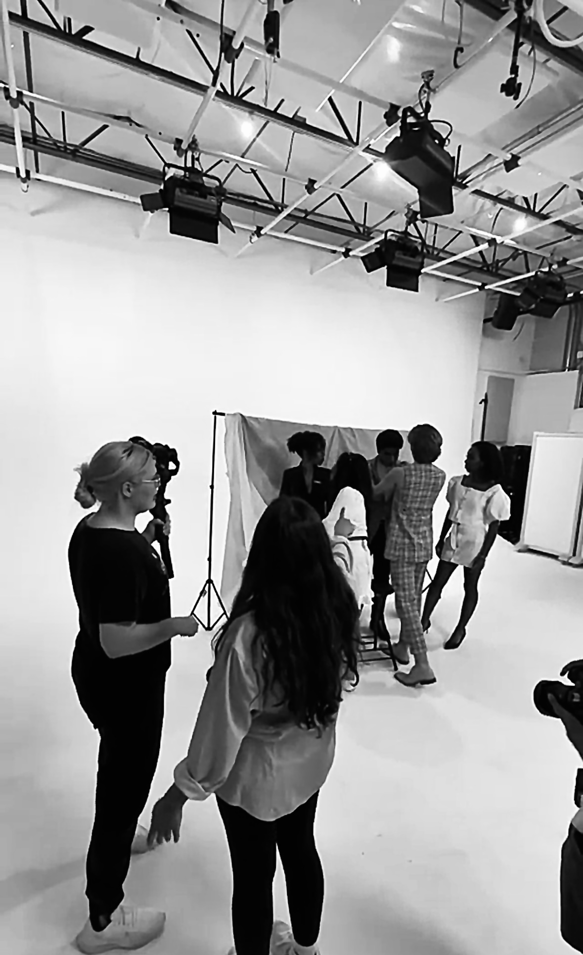 A behind-the-scenes view of a creative team working on a studio set