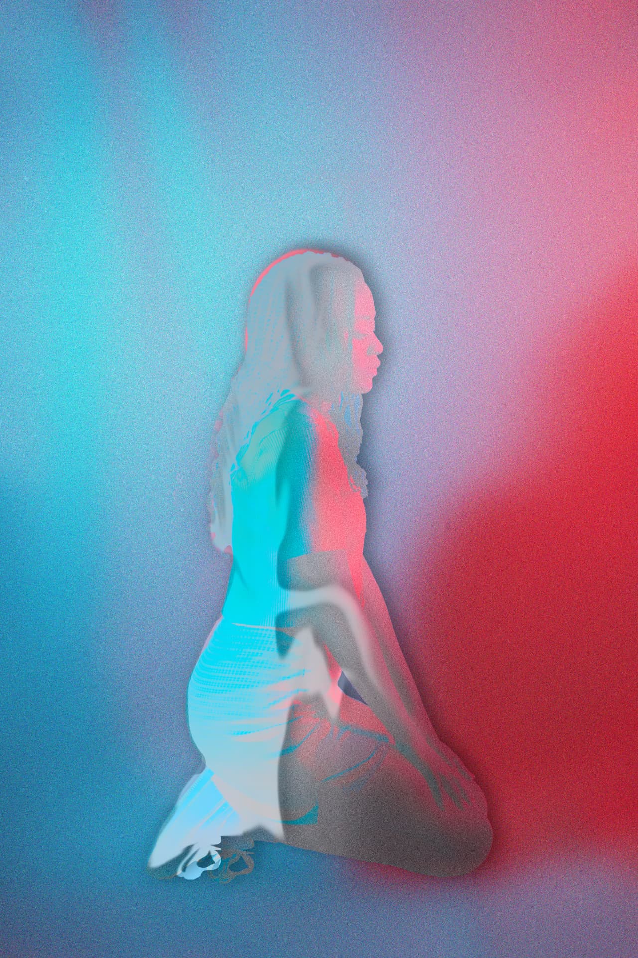 Kneeling figure washed in grainy blue and red light